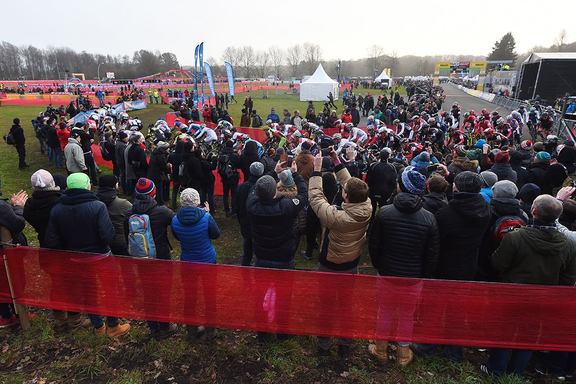 Fans take photos of the riders