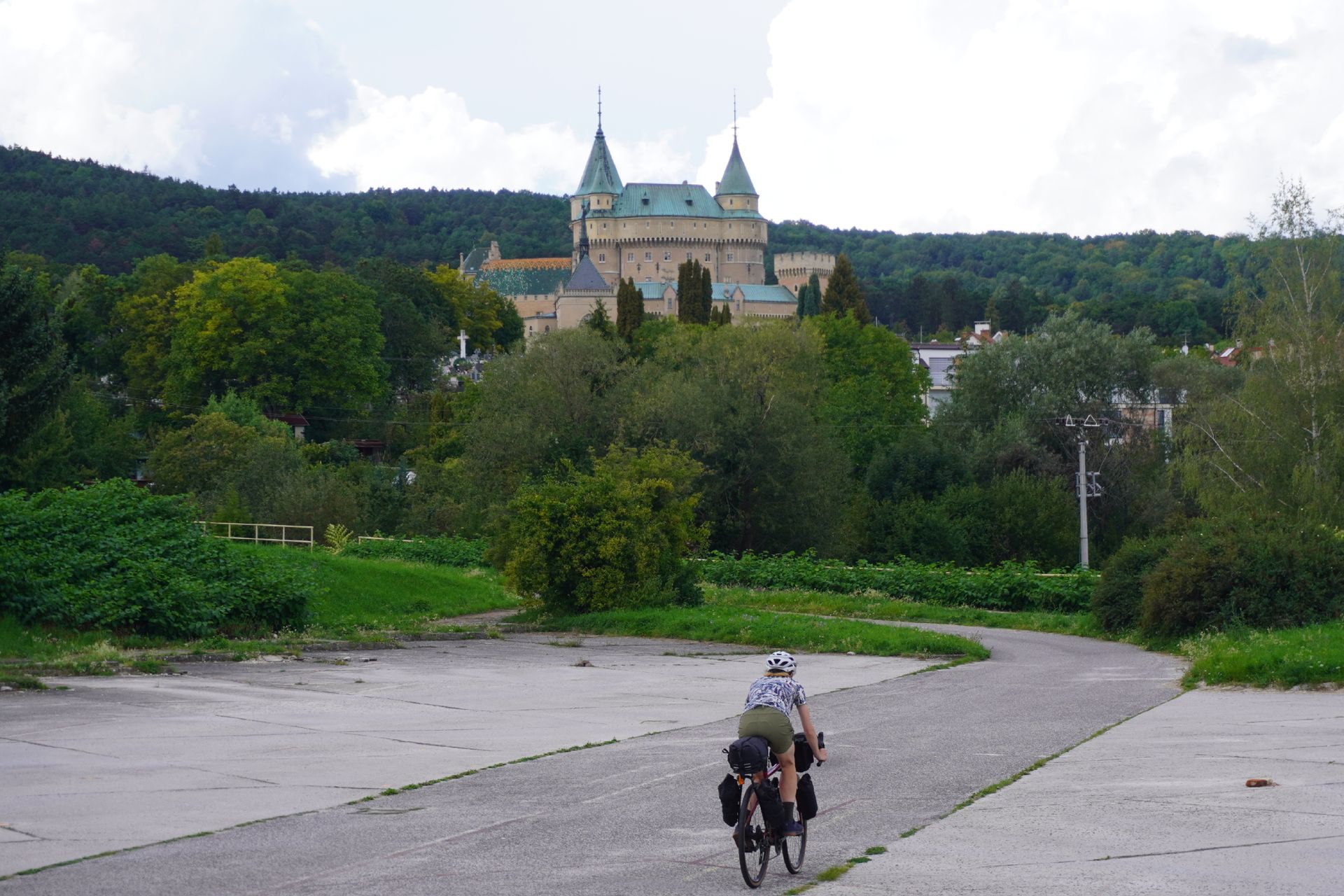 Image shows Anna cycling towards the Castle of Spirits (Bojnice Castle) in Slovakia