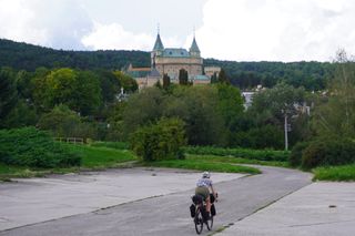 Image shows Anna cycling towards the Castle of Spirits (Bojnice Castle) in Slovakia