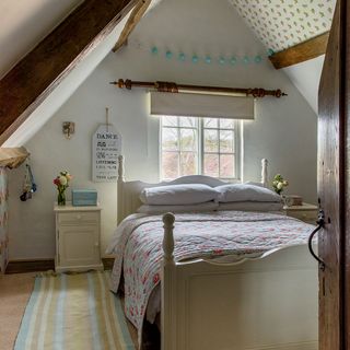 attic bedroom with bed and carpet flooring