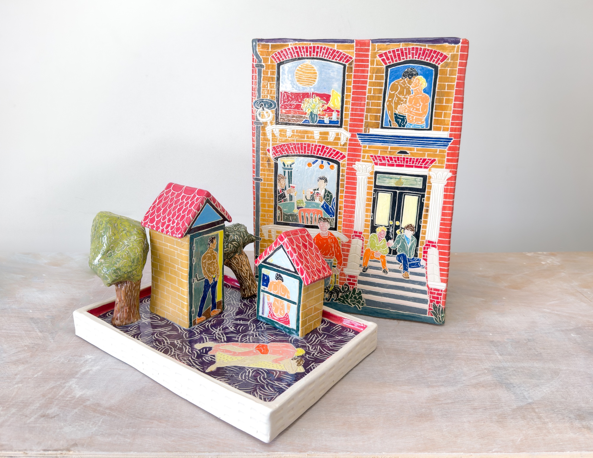 a ceramic house with images of gay shirtless men