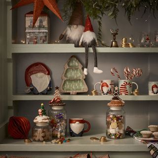 Gonk embossed plate, £12.99; Gonk mug, £9.99; Gonk barrel mug, £6.99; Gonk mug and coaster set, £9.99; Gonk side plate, £5.99; Modern tree wooden nibble bowl, £17.99; Novelty Christmas jars from £11.99; Santa and Nutcracker Christmas glasses (set of 4), £8.99; Santa table decoration, £4.99; Annie Wild embossed bakery shop tin, £8; Strawberry candy cane, £1; Sweets from £7