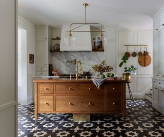 neutral kitchen with wooden island and patterned floor tiles