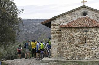 Mountain bikers by a church in Cyprus.