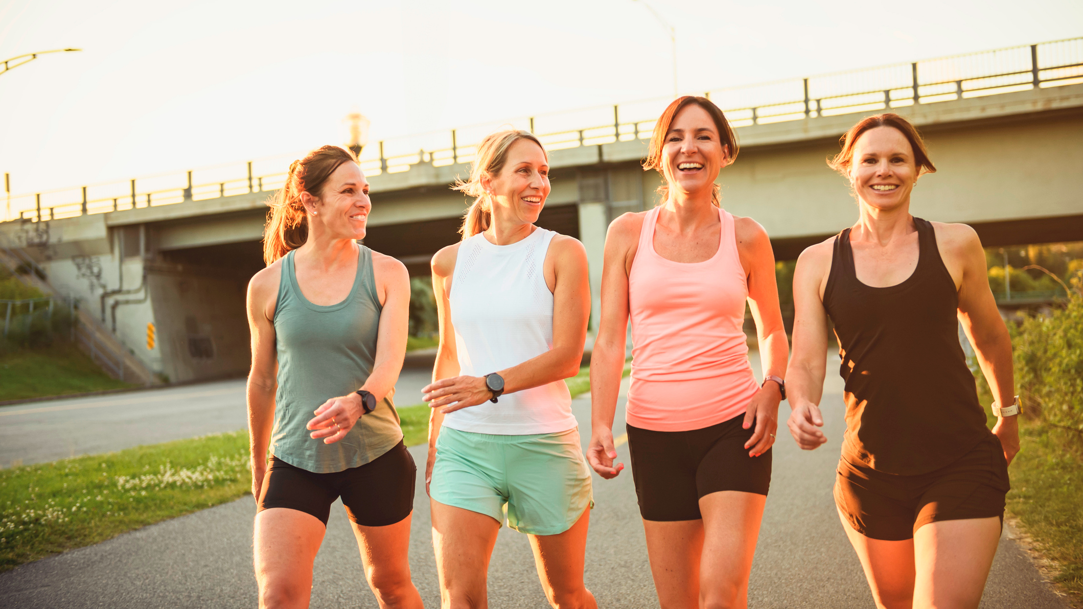 Four women in sportswear walking in a line