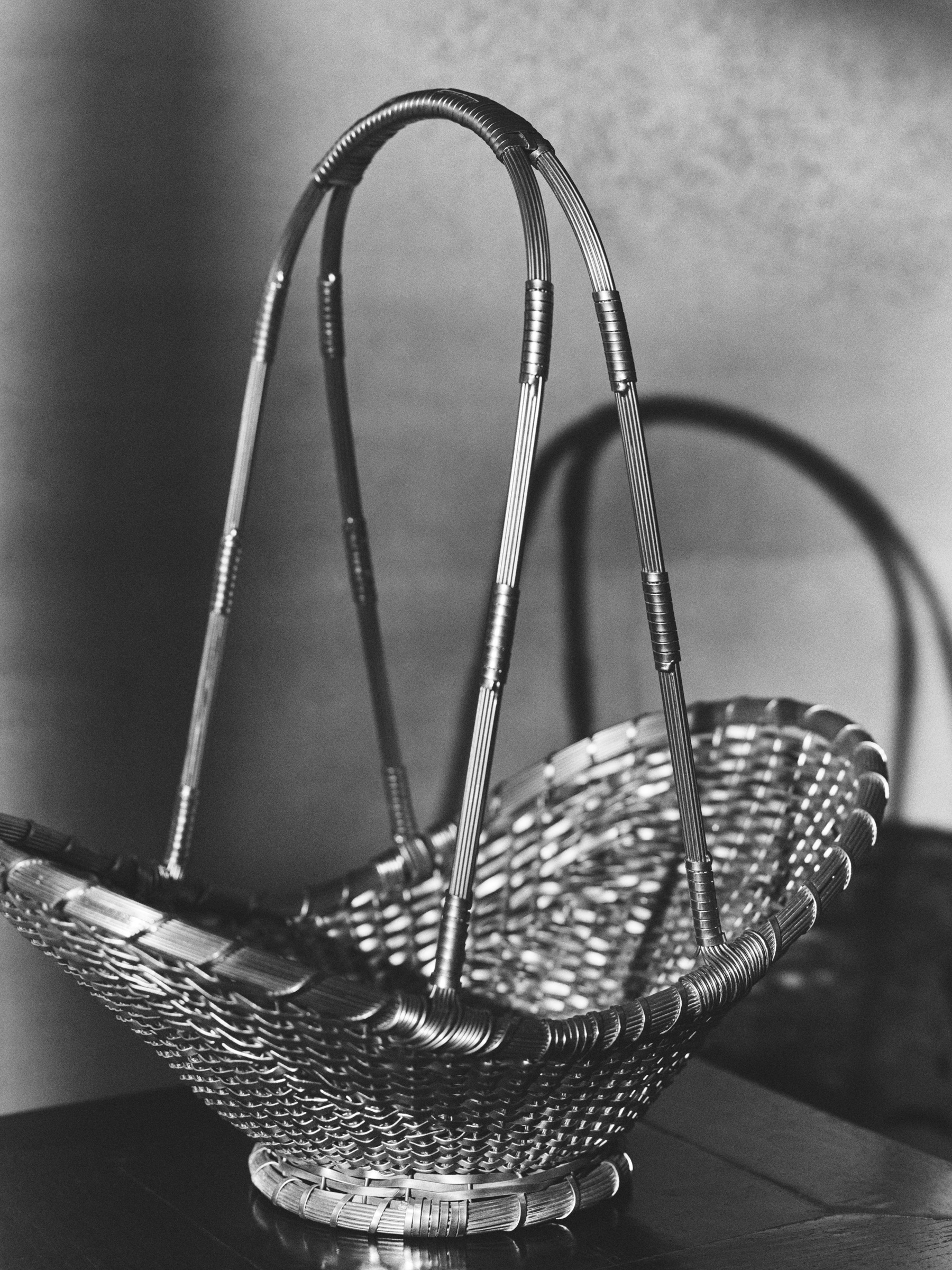 A series of products from Zara Home designed by NYC's Colin King, including red lacquered nesting tables, a red vessel, an egg-shaped lamp, and a basked woven in brass.  