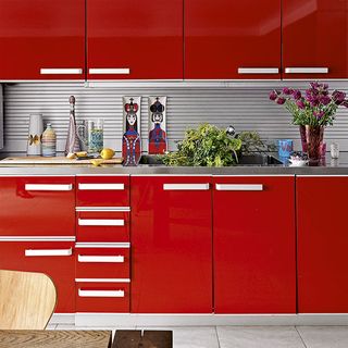 kitchen with red cabinets and flower vase