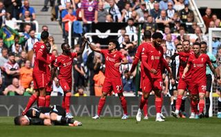 Naby Keita celebrates with teammate Luis Diaz of Liverpool after scoring their team's first goal during the Premier League match between Newcastle United and Liverpool at St. James Park on April 30, 2022 in Newcastle upon Tyne, England.