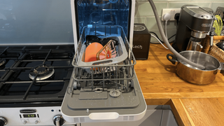 Image of items being sanitized with the UV light mode in Loch Capsule countertop dishwasher