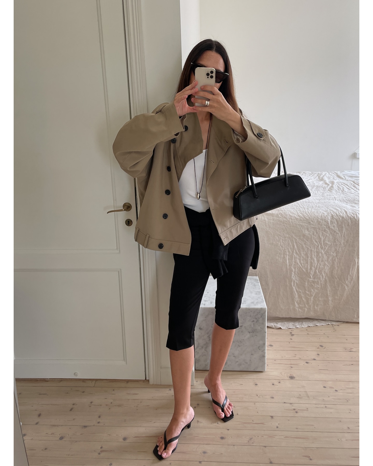johanna piispa wears a khaki jacket, capri trousers, and heeled flip flops