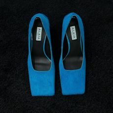 a close up of a pair of blue alaia square toe heels