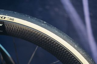 A close up of a tanwall Pirelli P Zero Race TLR RS bike tyre on a deep carbon rim.