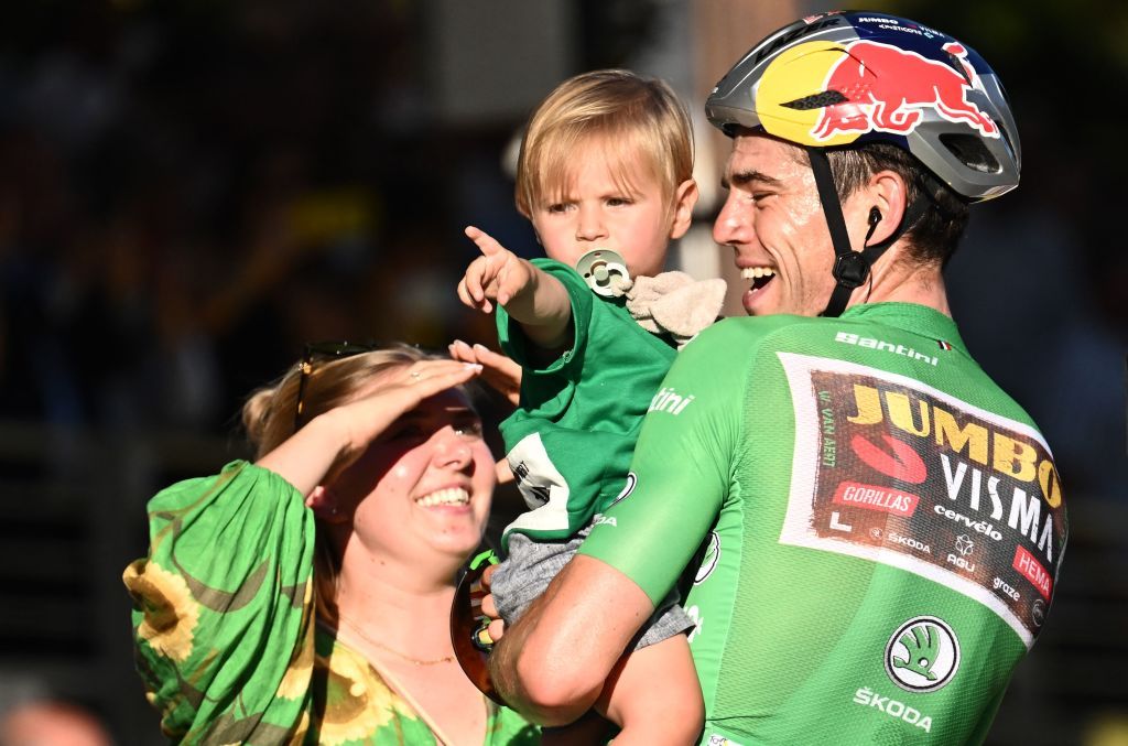 JumboVisma teams Belgian rider Wout Van Aert wearing the sprinters green jersey holds his son George next to his wife Sarah L after the 21st and final stage of the 109th edition of the Tour de France cycling race 1156 km between La Defense Arena in Nanterre outside Paris and the ChampsElysees in Paris France on July 24 2022 Photo by Marco BERTORELLO AFP Photo by MARCO BERTORELLOAFP via Getty Images