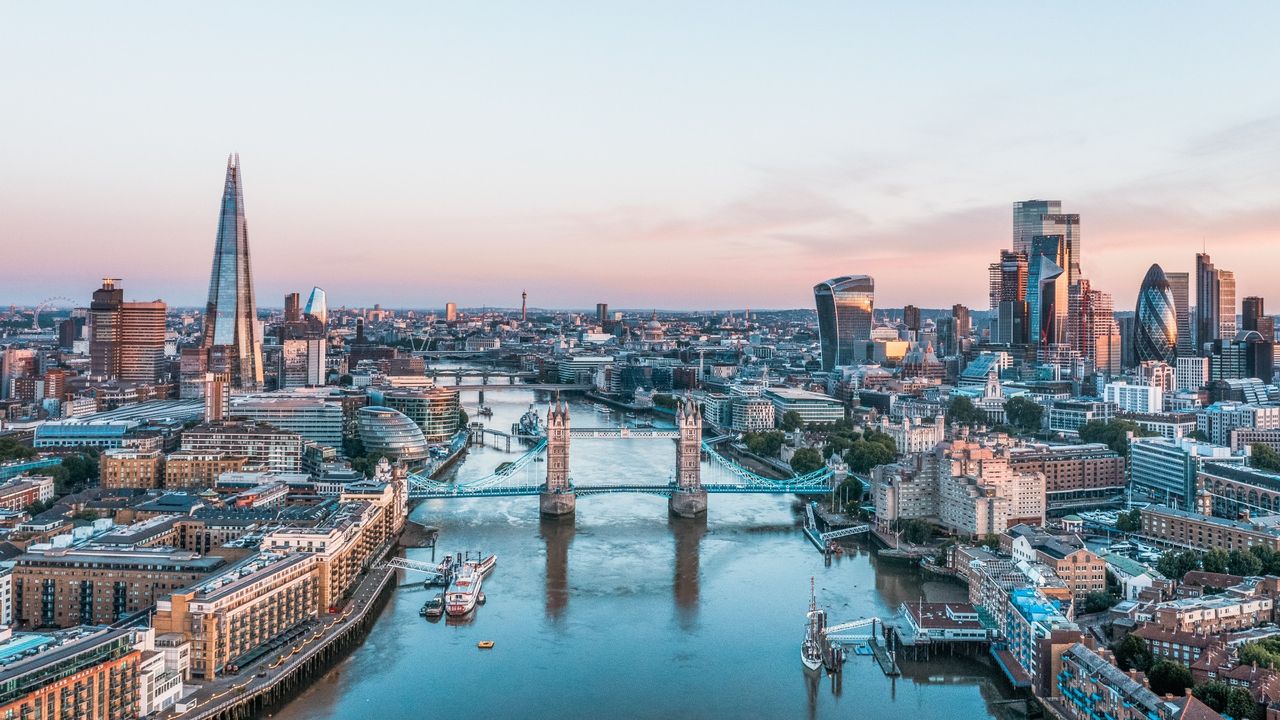 The London skyline at sunrise looking east with the Tower Bridge in the middle and The Shard to the left