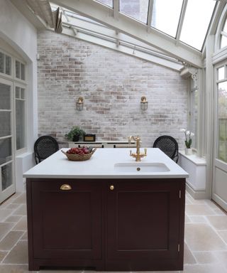 dark red kitchen island with sink in conservatory extension