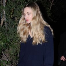 Amanda Seyfried wears the Reformation Jadey jumper with black pointed-toe heels.