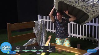 Jerma holding a mattress above his head in his IRL Sims stream