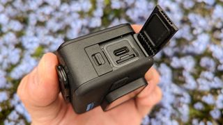 GoPro Hero 11 Black Mini with slide flap open to show USB-C socket and a mini SD card slot