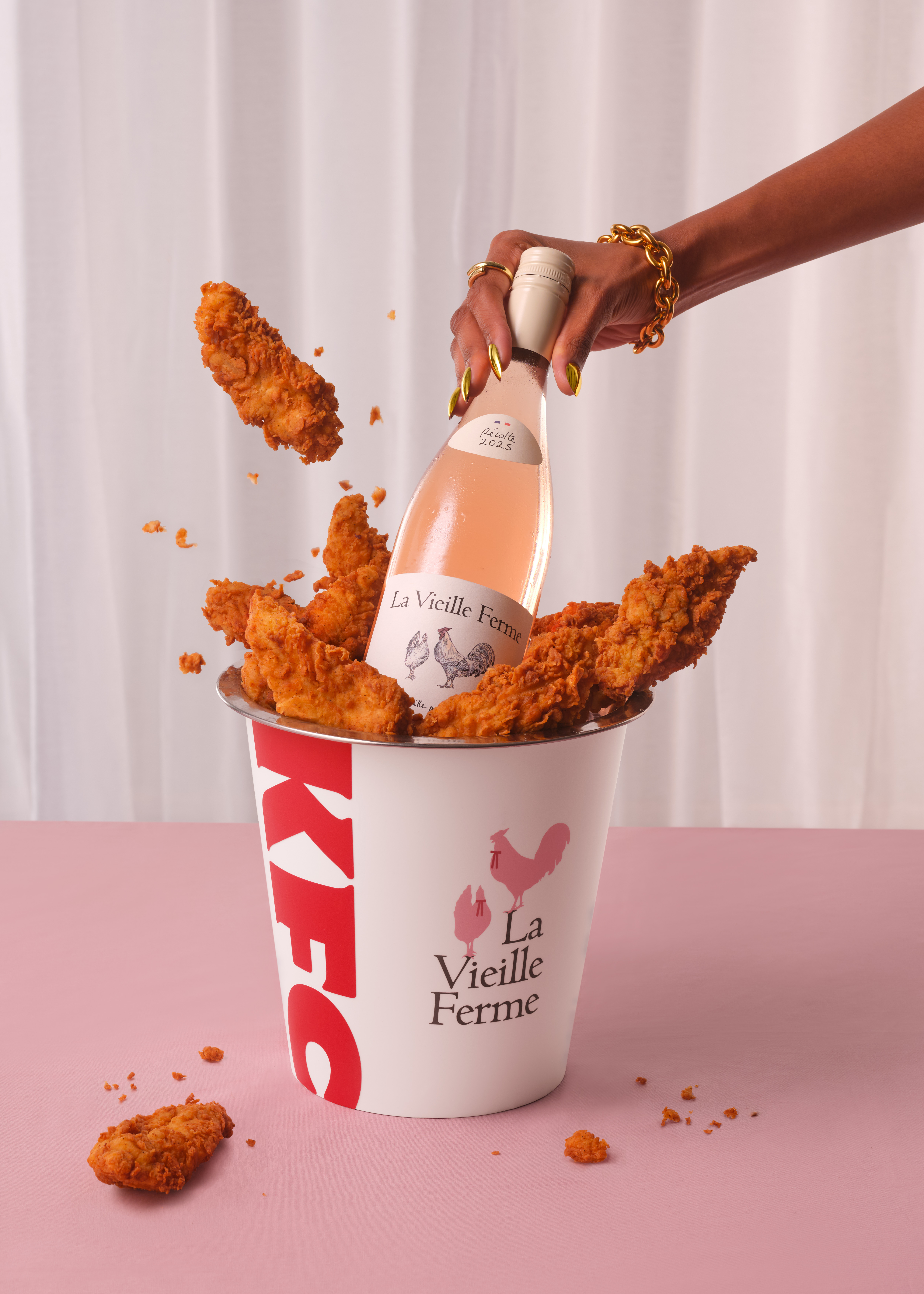 an image of a bottle of La Vieille Ferme in a KFC-branded wine cooler bucket with chicken