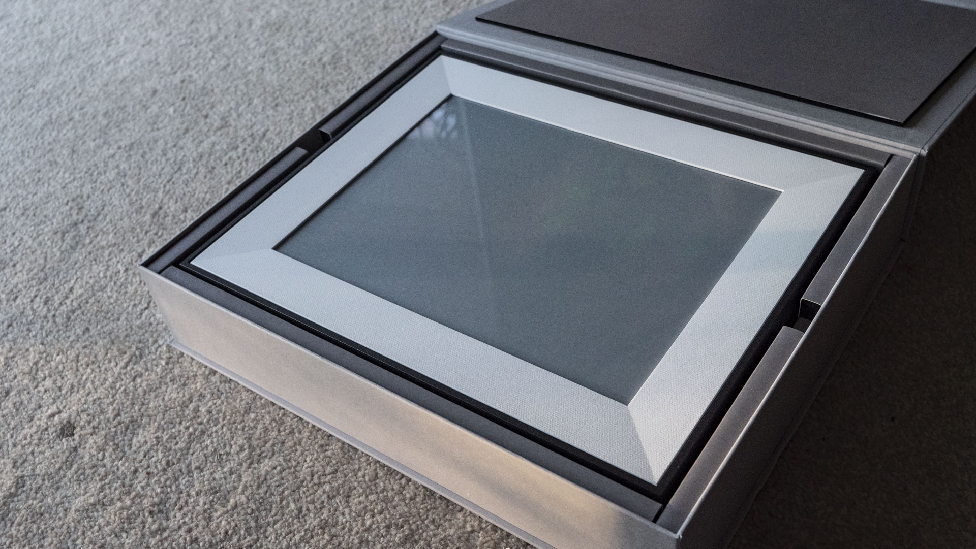 The Aura Ink 'E Ink' digital photo frame's presentation box, opened with the frame inside