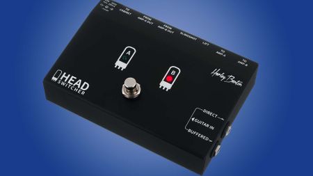 Harley Benton Head Switcher; this black single-footswitch pedal is an affordable switching solution for players with two amp heads sharing one speaker cabinet, and is here photographed against a blue gradient background.