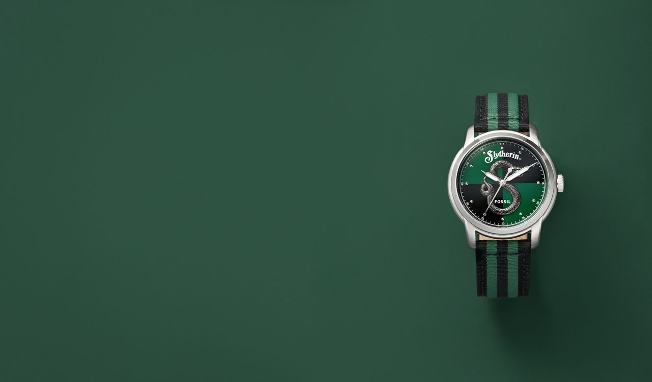 A Harry Potter x Fossil Nylon watch, in the Slytherin design, on a green background
