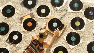 A woman lies on the floor surrounded by LPS