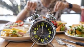 Image of plate of food with a clock