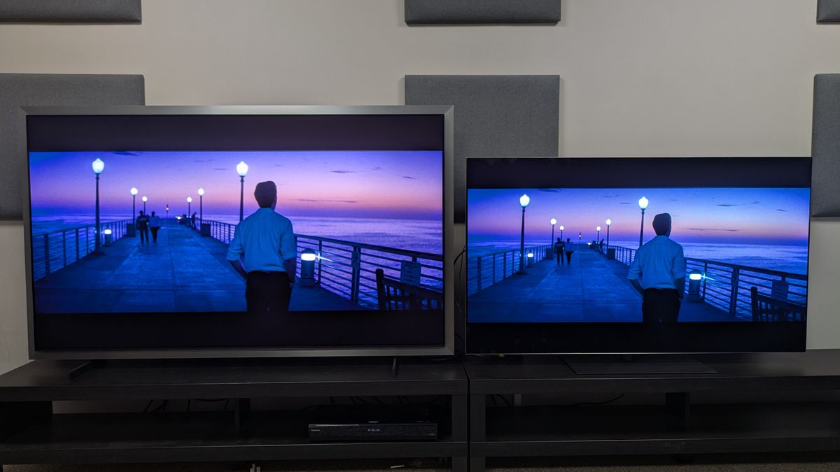 Samsung S99H (left) vs LG G6 (right) showing Sebastian walking on a pier at sunset from La La Land. Both TVs accurately render the gradient of the sunset