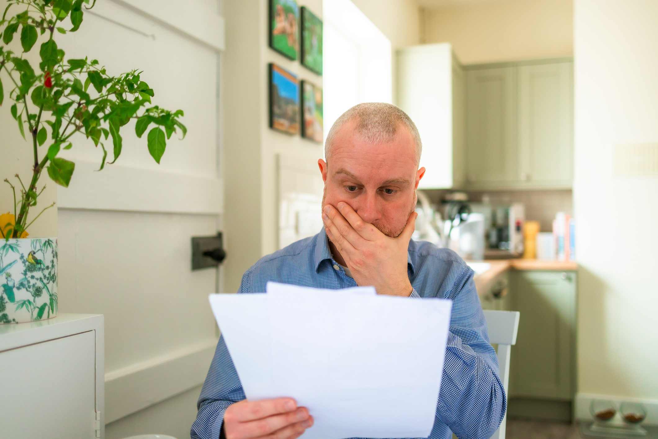 a man surprised reading a letter