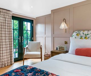 loft conversion bedroom with Juliet balcony and pale pink wooden wall cladding