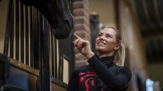 World champion Lottie Fry pictured stroking the nose of one of the horses at the van Olst&rsquo;s indoor yard in the Netherlands
