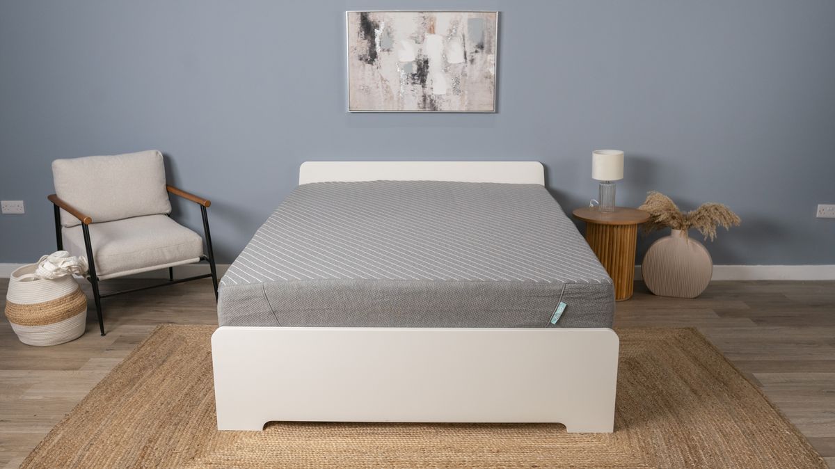 The Siena Memory Foam Mattress placed on a white bed frame in our blue testing bedroom