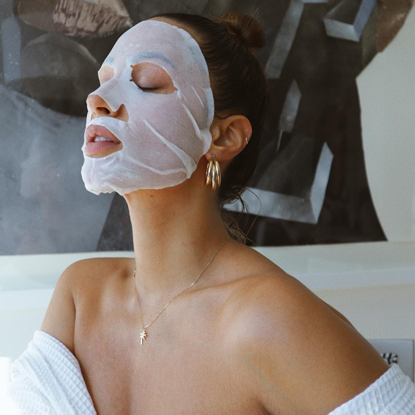 A woman using a sheet mask