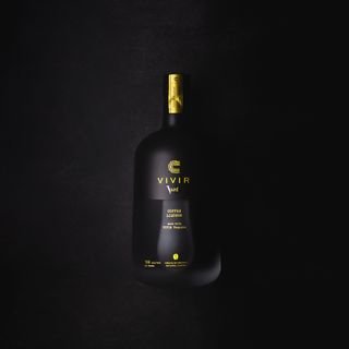 A bottle of VIVIR Café VS coffee tequila pictured against a black background