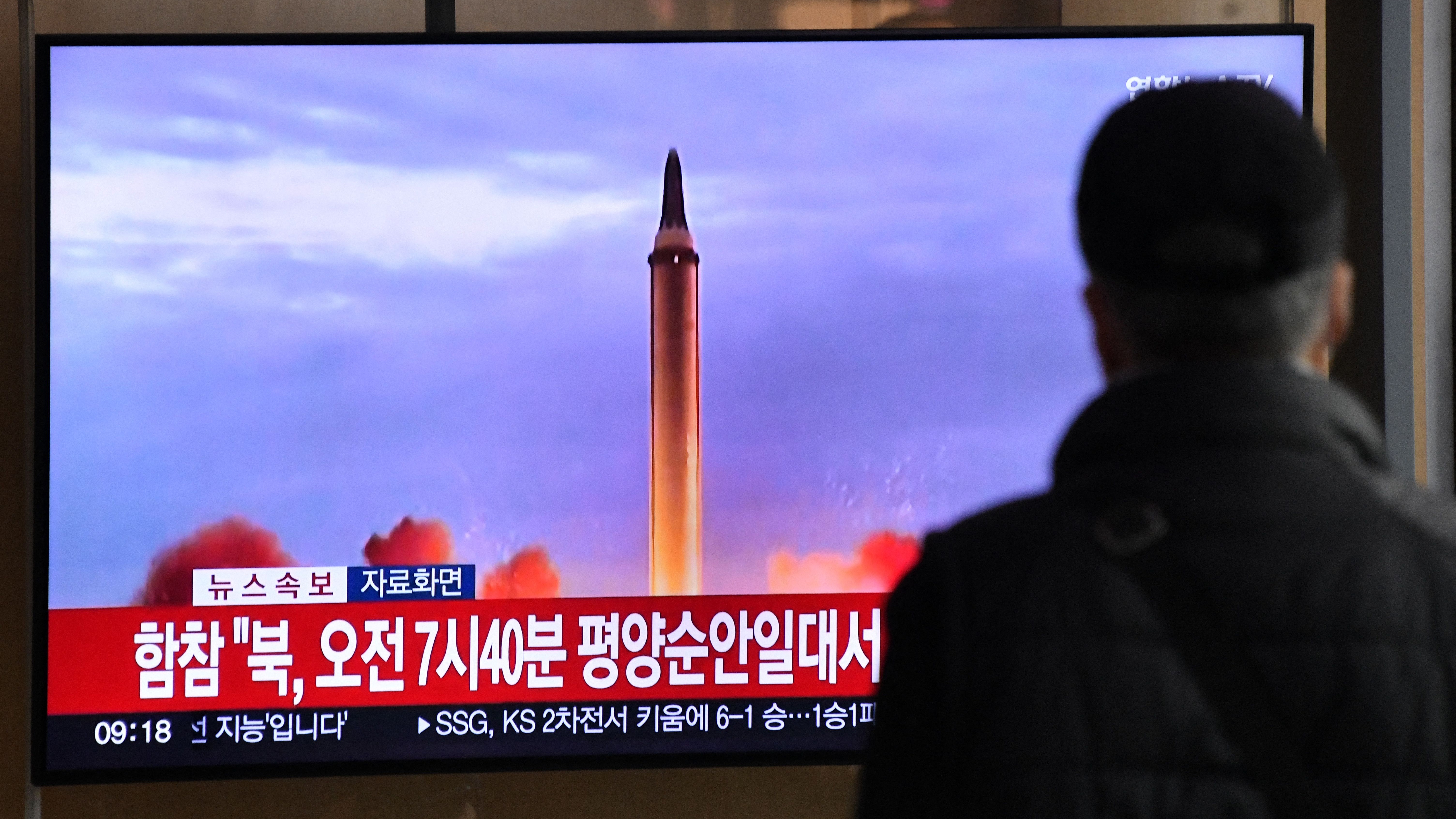 A passerby in Seoul, South Korea watches footage of a North Korean missile blasting off on Nov. 3, 2022.