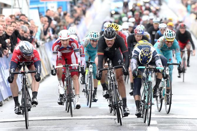 Andre Greipel (Lotto Belisol) looks across at Tom Boonen and Danny van Poppel on the finish line