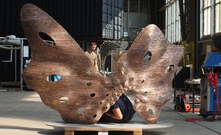 A copper structure resembling a butterfly with open wings