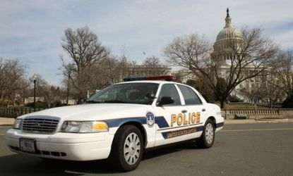 A police car sits in front of the U.S. Capitol building Friday, after FBI agents arrested a Moroccan man for allegedly plotting to attack the Capitol.