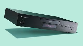 The Panasonic DP-UB9000 Blu-ray player on a green surface
