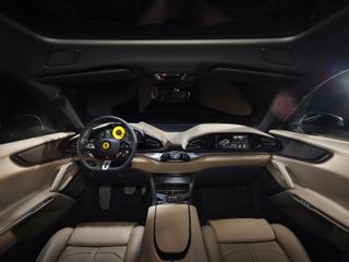 Close up image of a Ferrari Purosangue car interior, beige leather seating, door cards and centre console, black roof lining, black steering wheel, car windows
