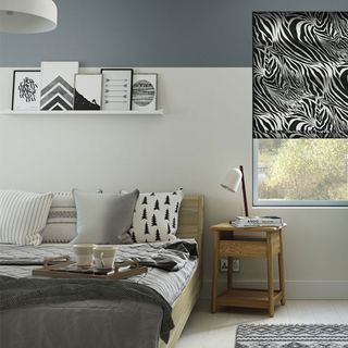 grey and white bedroom with black and white zebra blind