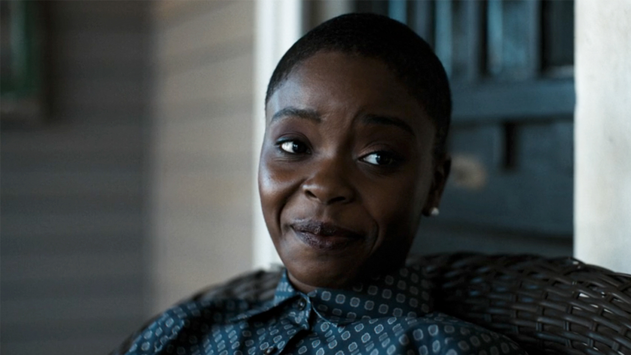 Joy Sunday smiling on a front porch in DTF St. Louis