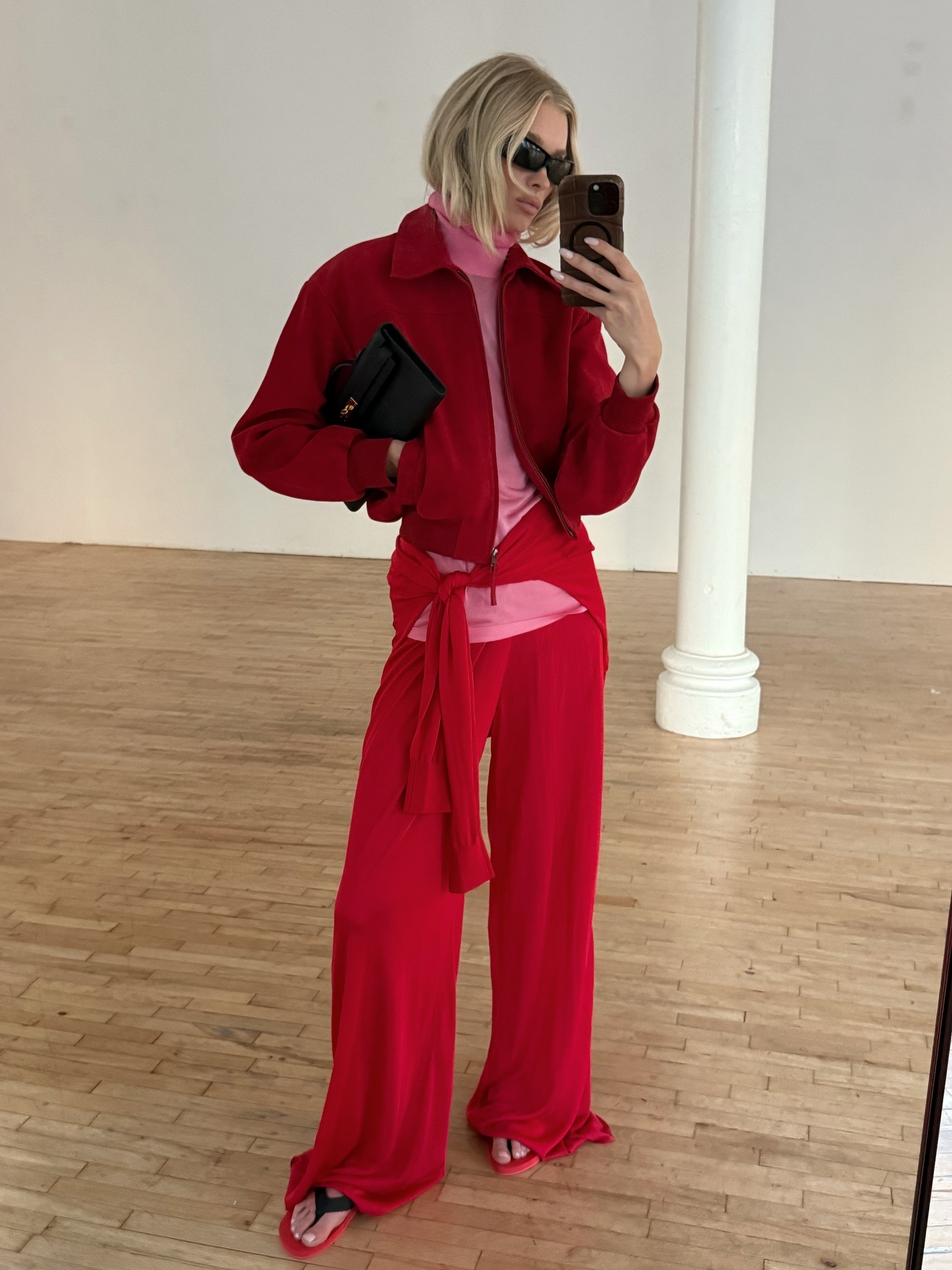 Elsa Hosk takes a mirror selfie wearing the pink and red colour trend.