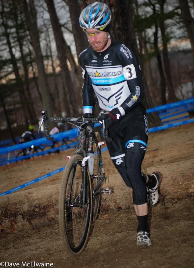 Shawn Milne (Keough Cyclocross) running the log barriers with one lap to go
