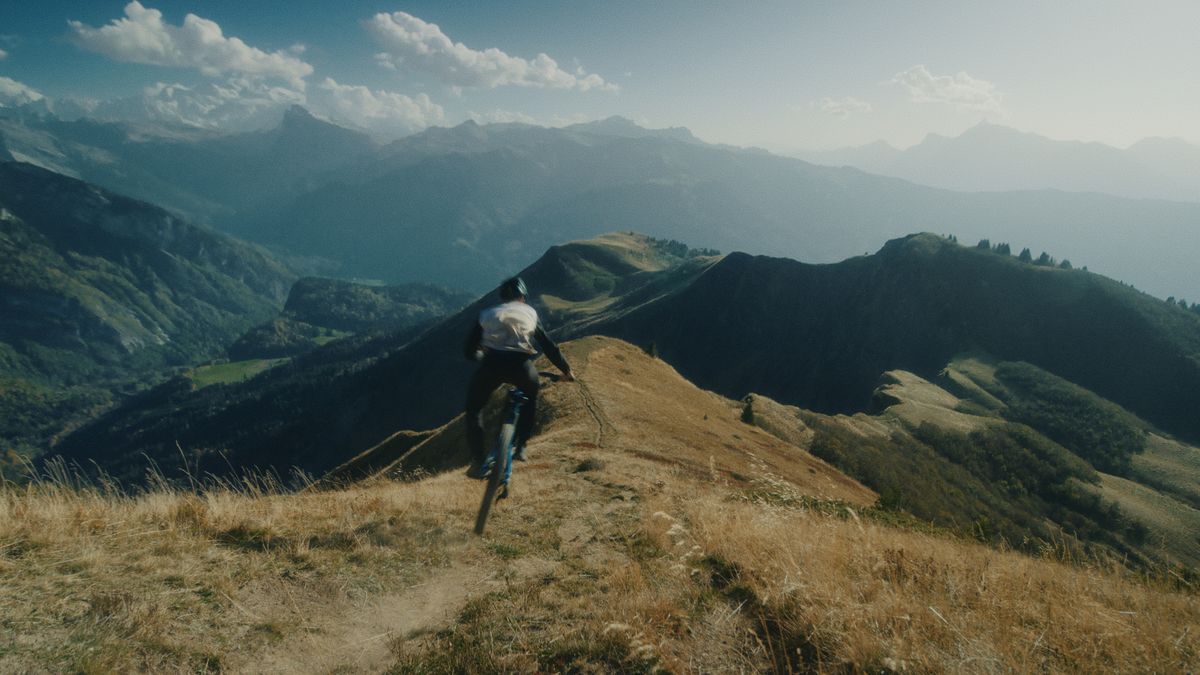 Louis Citadelle riding an Alpine mountain ridge