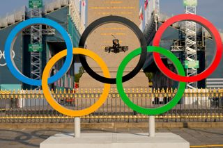 A drone flies through the Olympic rings in Paris, July 2024