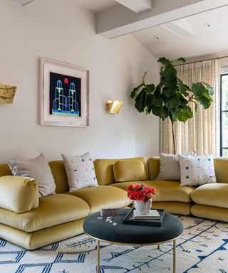 living room with mustard yellow sectional and patterned rug