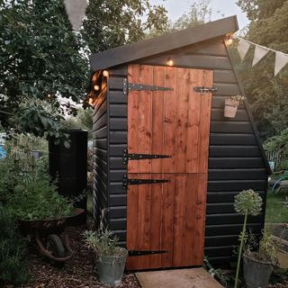 Black she shed with wooden door