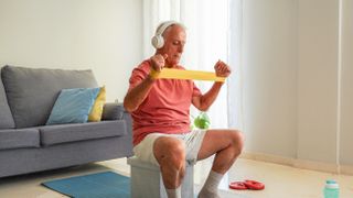 a senior man doing a resistance band workout